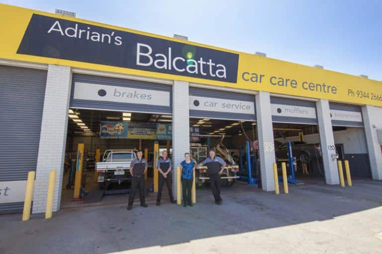 employees of adrian's balcatta car care centre posing for a photo in from of their workshop