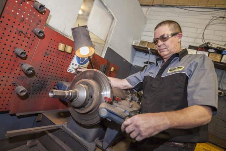 auto mechanic skimming a vehicle clutch in adrian's balcatta car centre