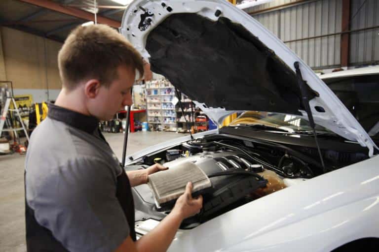 auto mechanic cleaning car filter in adrian's balcatta car centre workshop