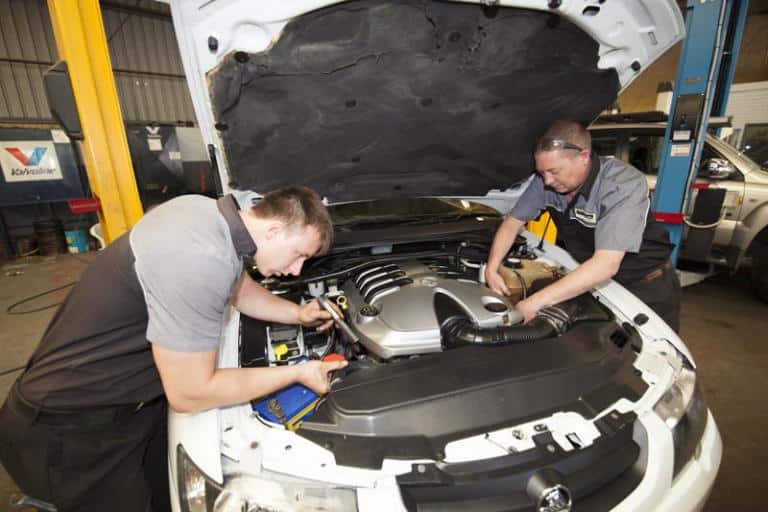 mechanics examining under hood of car at the car service centre in balcatta